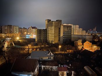 High angle view of illuminated buildings against sky at night