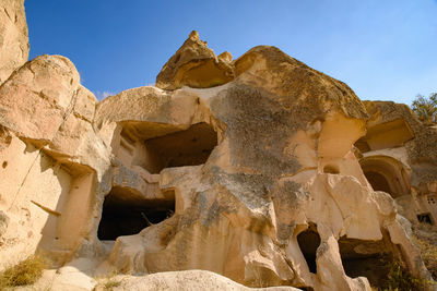 Low angle view of rock formation against sky