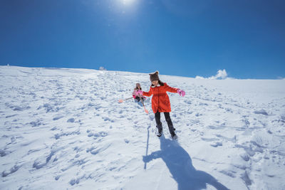 Full length of woman skiing on snow