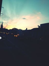 View of illuminated city at sunset