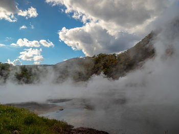 Landscape shot of sulfuric gas from lake against sky