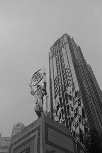 Low angle view of statue of city against clear sky