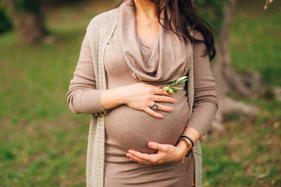 Midsection of woman standing against blurred background