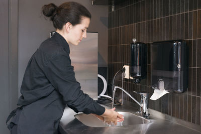 Woman washing hands at work