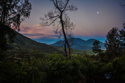 Scenic view of mountains against sky at sunrise