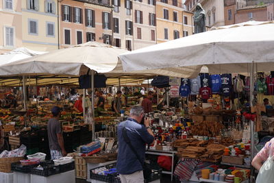 People at market stall in city