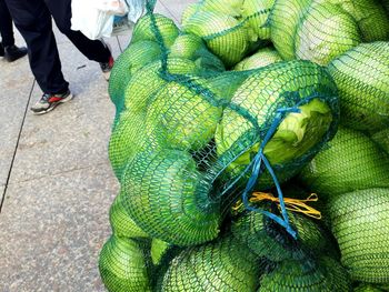 Low section of man walking by vegetables