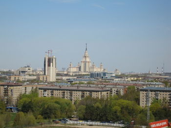 View of buildings in city against clear sky