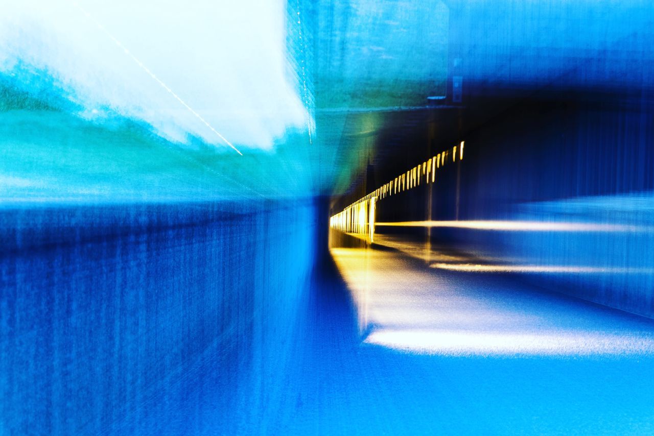 blue, architecture, tunnel, motion, long exposure, transportation, reflection, blurred motion, light, sunlight, speed, illuminated, no people, line, futuristic, abstract, wave, the way forward, built structure, city, light - natural phenomenon, road, wall - building feature, azure, nature, indoors