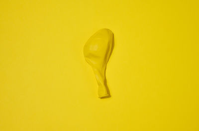 Low section of woman standing against yellow background