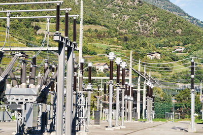 High angle view of electric power station amidst trees in city