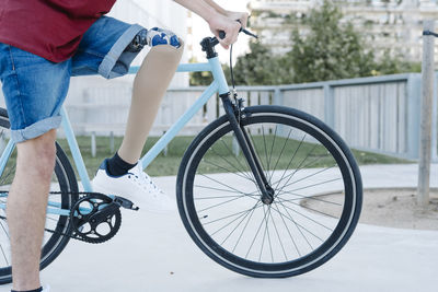 Young disabled cyclist riding bike in city