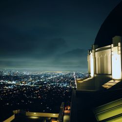 Illuminated cityscape against sky at night