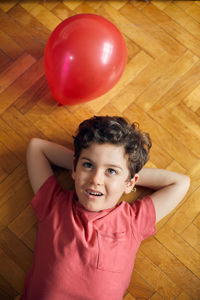 High angle portrait of baby girl on hardwood floor