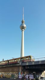 Low angle view of fernsehturm television tower against clear sky