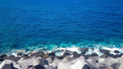 High angle view of rocks by sea