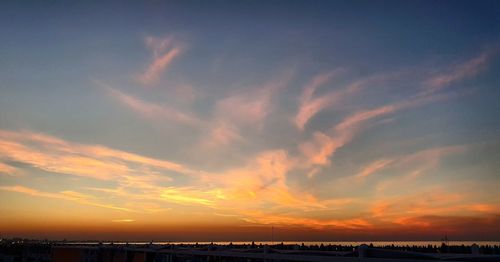 Scenic view of sea against romantic sky at sunset