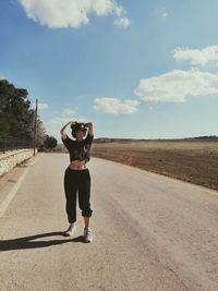 Full length of woman on road against sky