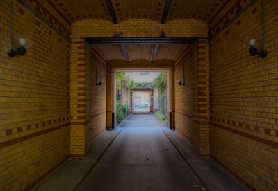 Narrow pathway along walls in garden