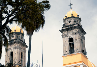 Low angle view of church and building against sky