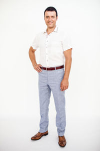 Portrait of a smiling man standing against white background