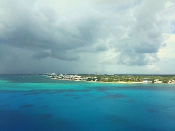 Scenic view of calm sea against cloudy sky