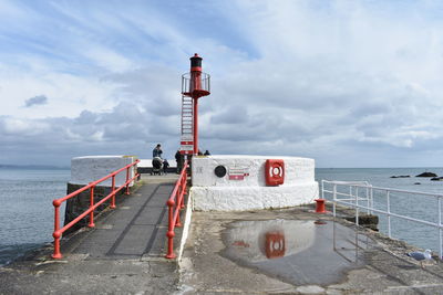 Lifeguard hut by sea against sky