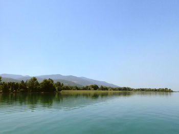 Scenic view of calm lake against clear sky