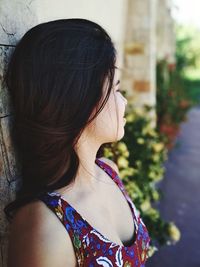 Close-up of young woman by wall