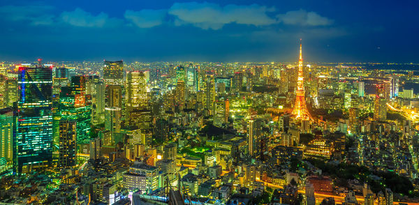 High angle view of illuminated cityscape against sky at night