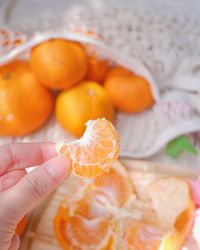 Close-up of hand holding orange