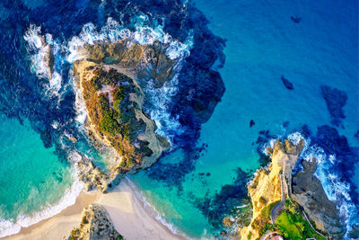 Aerial view of sea by rock formation