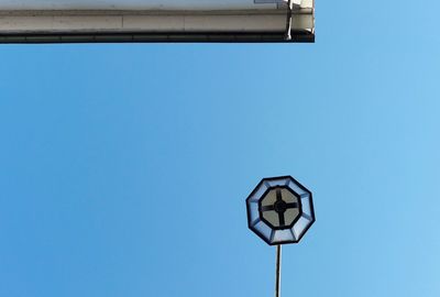 Low angle view of windmill against clear blue sky