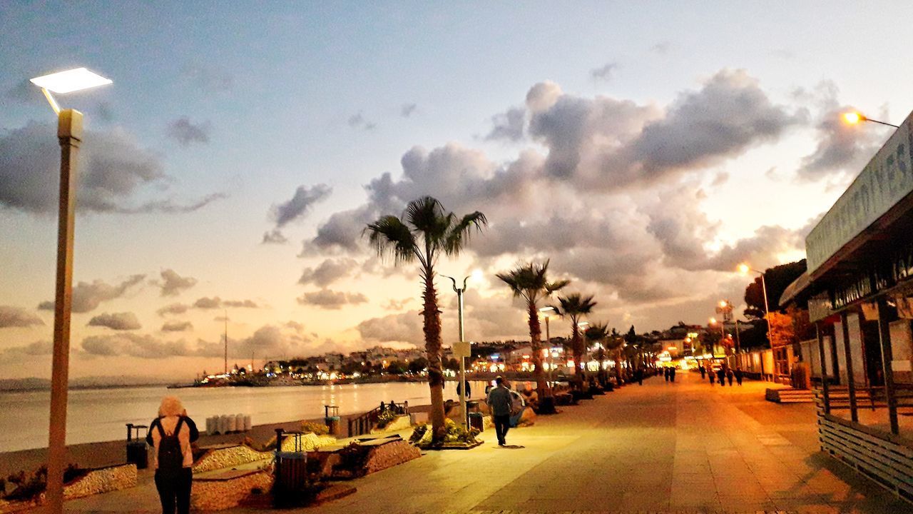 PANORAMIC VIEW OF PEOPLE AT BEACH AGAINST SKY