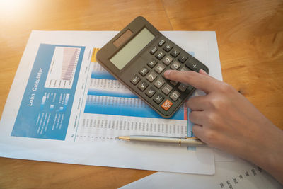 High angle view of man using smart phone on table