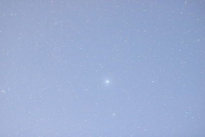 Low angle view of star field against clear blue sky