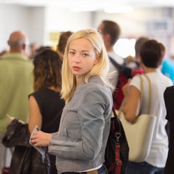 Portrait of mid adult woman standing at airport