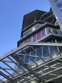 Low angle view of modern building against clear blue sky