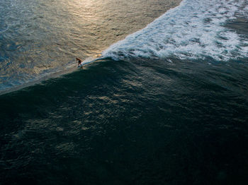 Aerial view of man surfing in sea