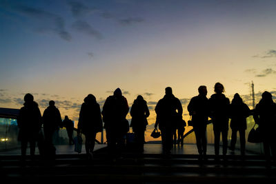 Silhouette people standing on ponte della costituzione during sunset