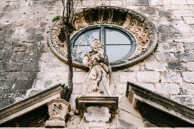 Low angle view of statue against building