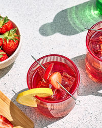 Fresh summer strawberry cocktail or mocktail on the table in garden. sparkling strawberry lemonade.