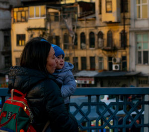 Couple kissing in city during winter