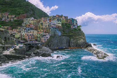 Scenic view of sea and buildings against sky