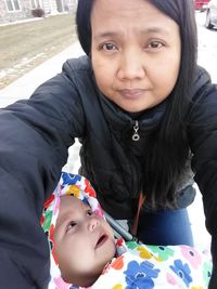 Portrait of mother and daughter outdoors