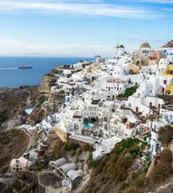 High angle view of townscape by sea against sky