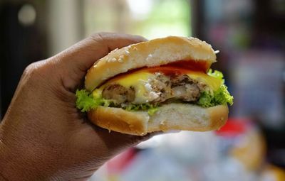 Close-up of hand holding burger