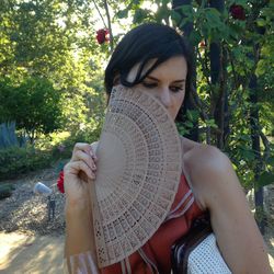 Close-up of young woman against tree