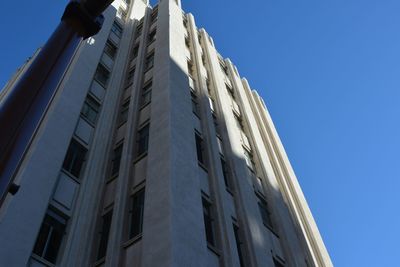 Low angle view of buildings against clear blue sky