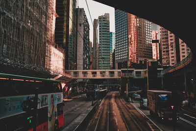 Railroad tracks by buildings in city